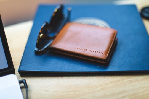 wallet and sunglasses on table